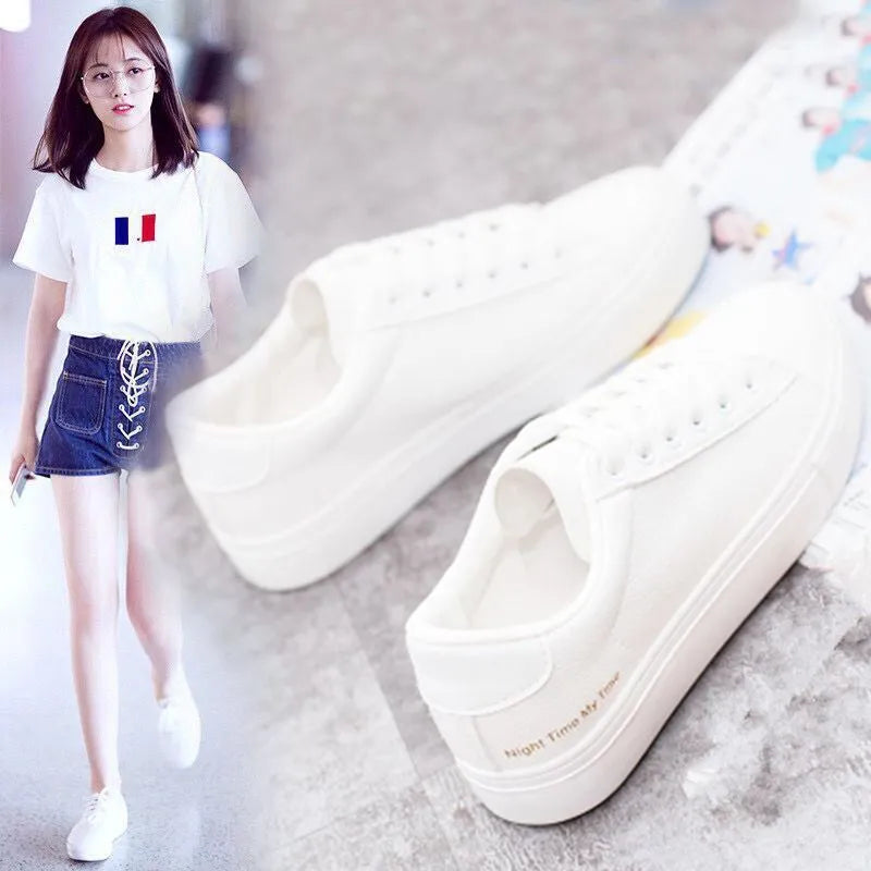 Women's white canvas sneakers with rubber sole and lace-up closure