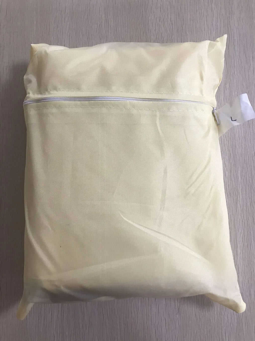 Beige polyester outdoor barbecue dust cover with Nordic style design shown folded