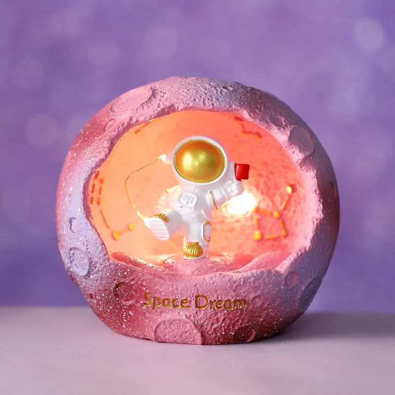 Cartoon spaceman synthetic resin night light ornament in astronaut design on a table