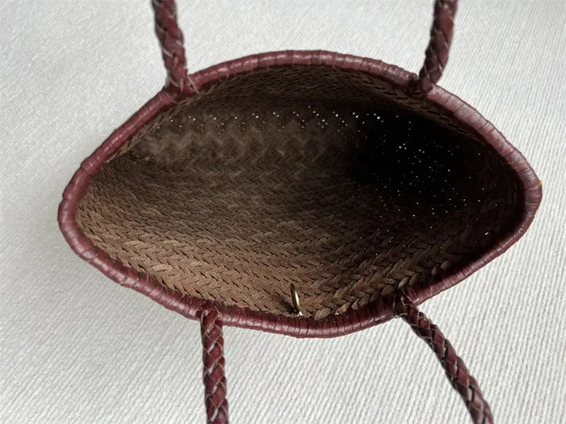 Handmade brown woven cowhide leather tote bag with a structured front pocket.