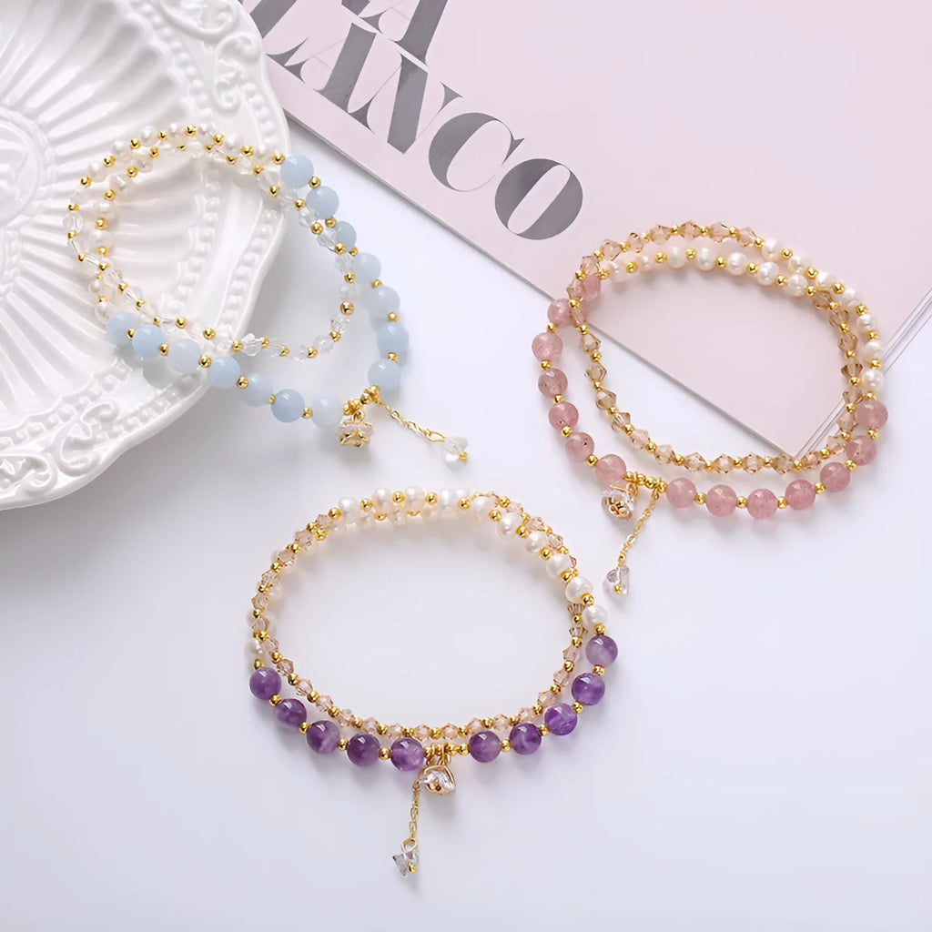 Handmade women's double ring bracelet with freshwater pearls and a central amethyst crystal.