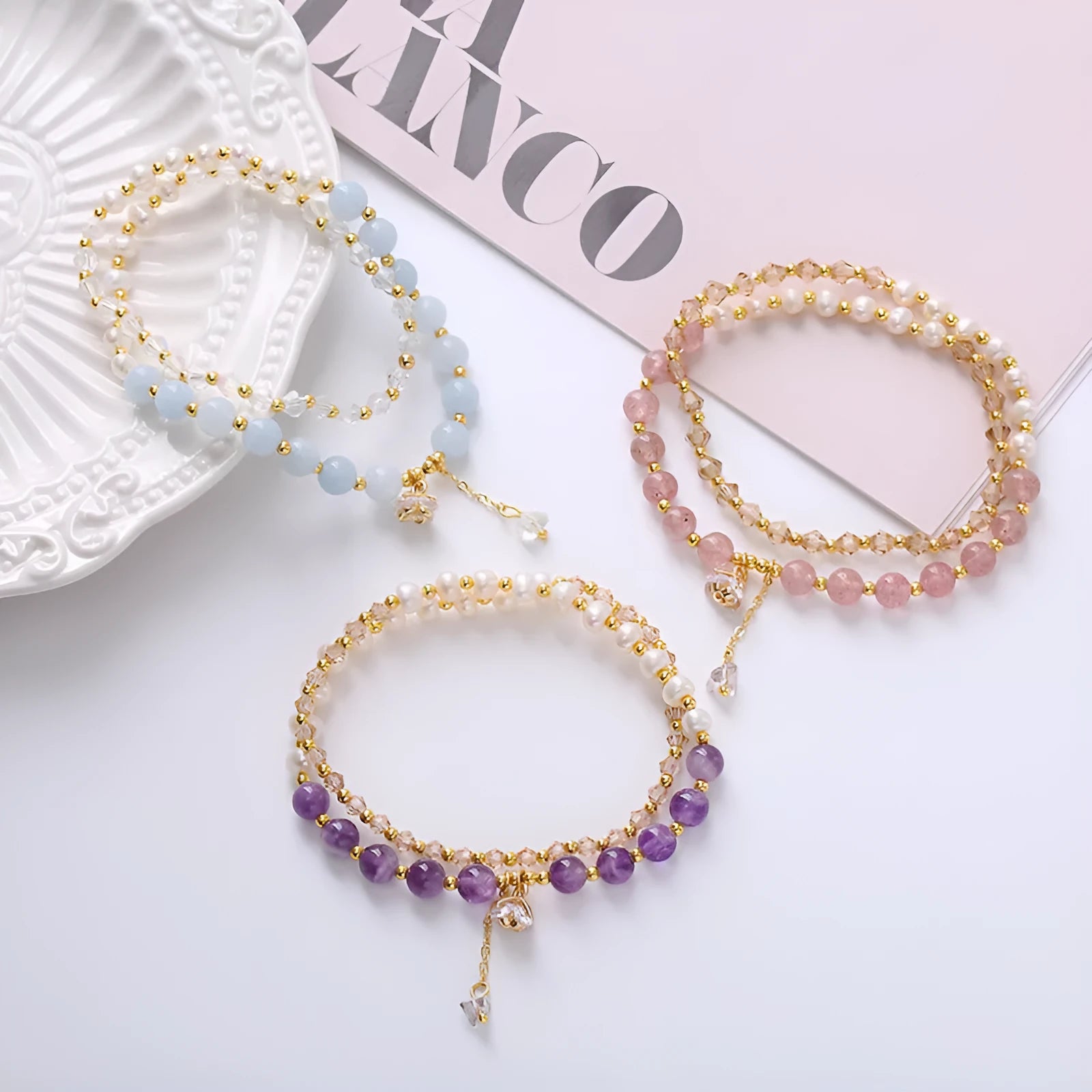 Handmade women's double ring bracelet with freshwater pearls and a central amethyst crystal.