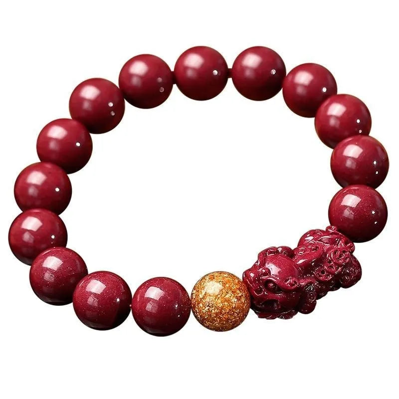Polished cinnabar and Purple Gold Sandstone bracelet with totem design on wrist.