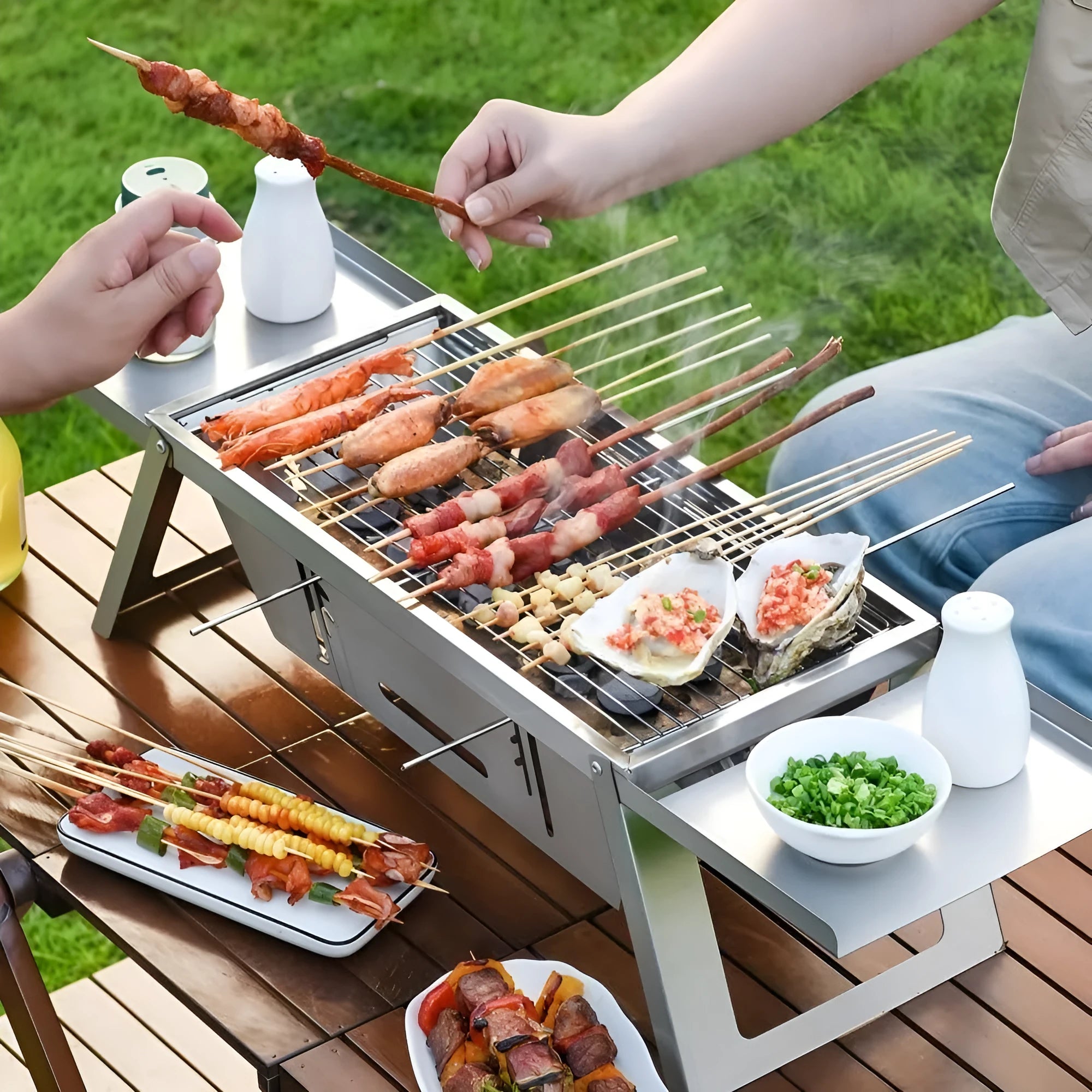 A small, foldable portable charcoal grill for outdoor cooking.