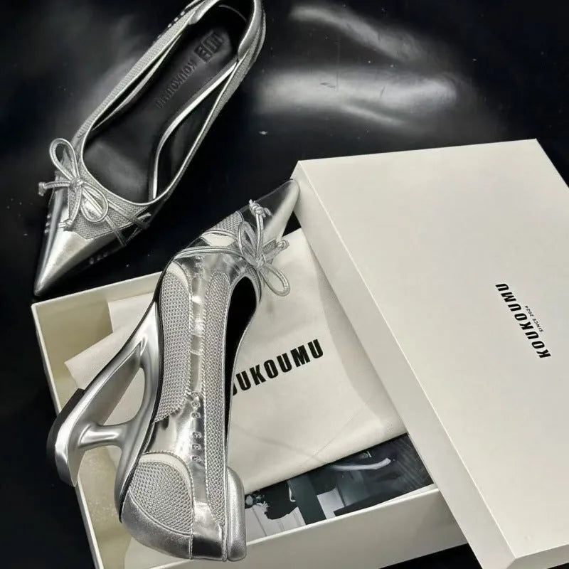 Black women's pointed toe Mary Jane shoes with a distinctive floating shaped heel and slip-on strap.