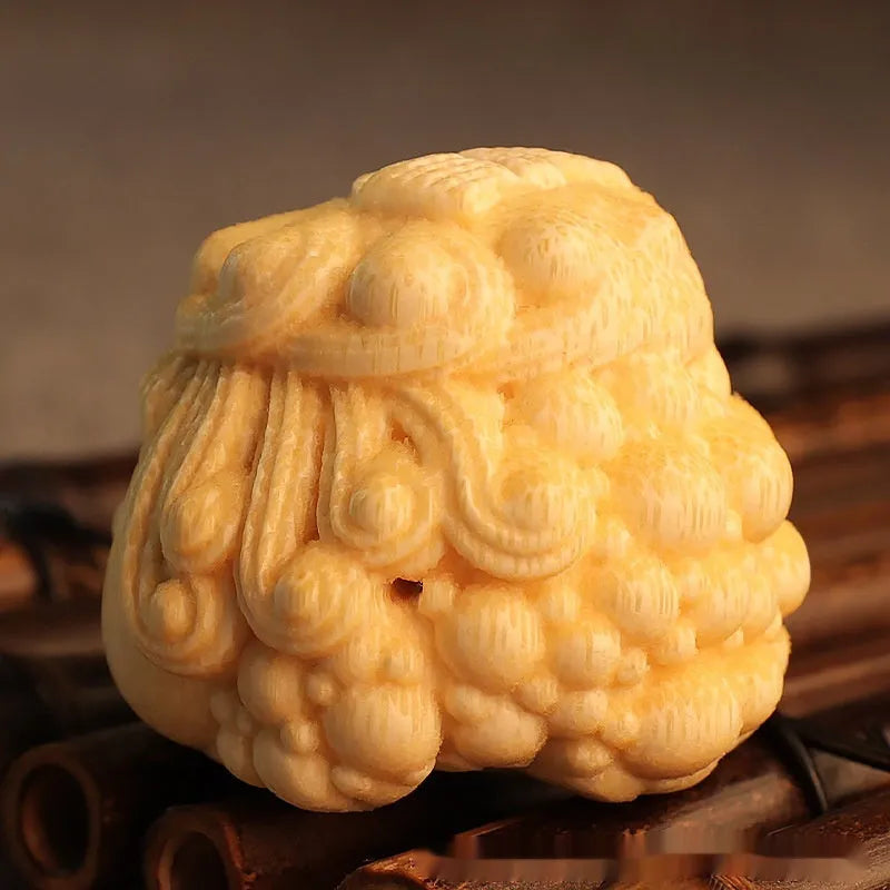 Solid bamboo carving of a cute golden toad princess ornament, 5 cm tall, on a plain background.