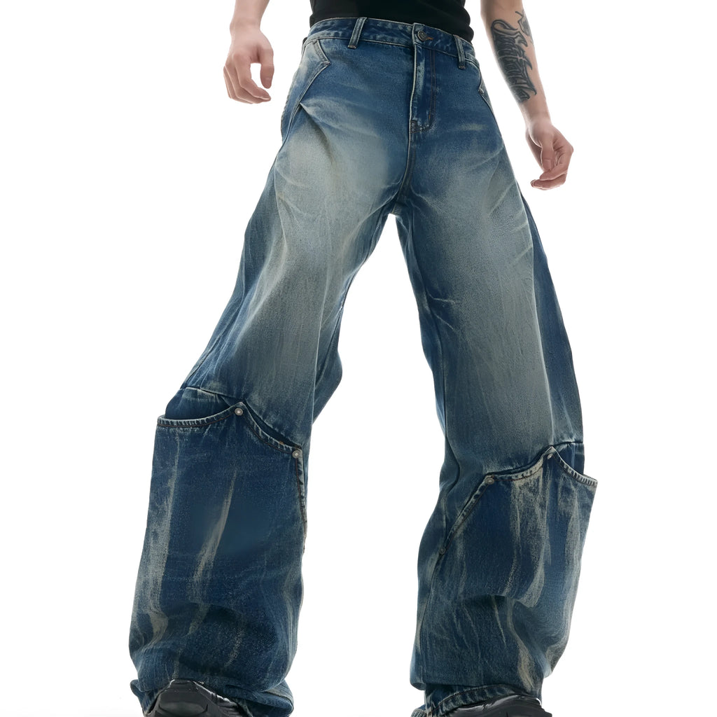 Man wearing verdant blue loose-fit retro jeans with a washed burst pattern.