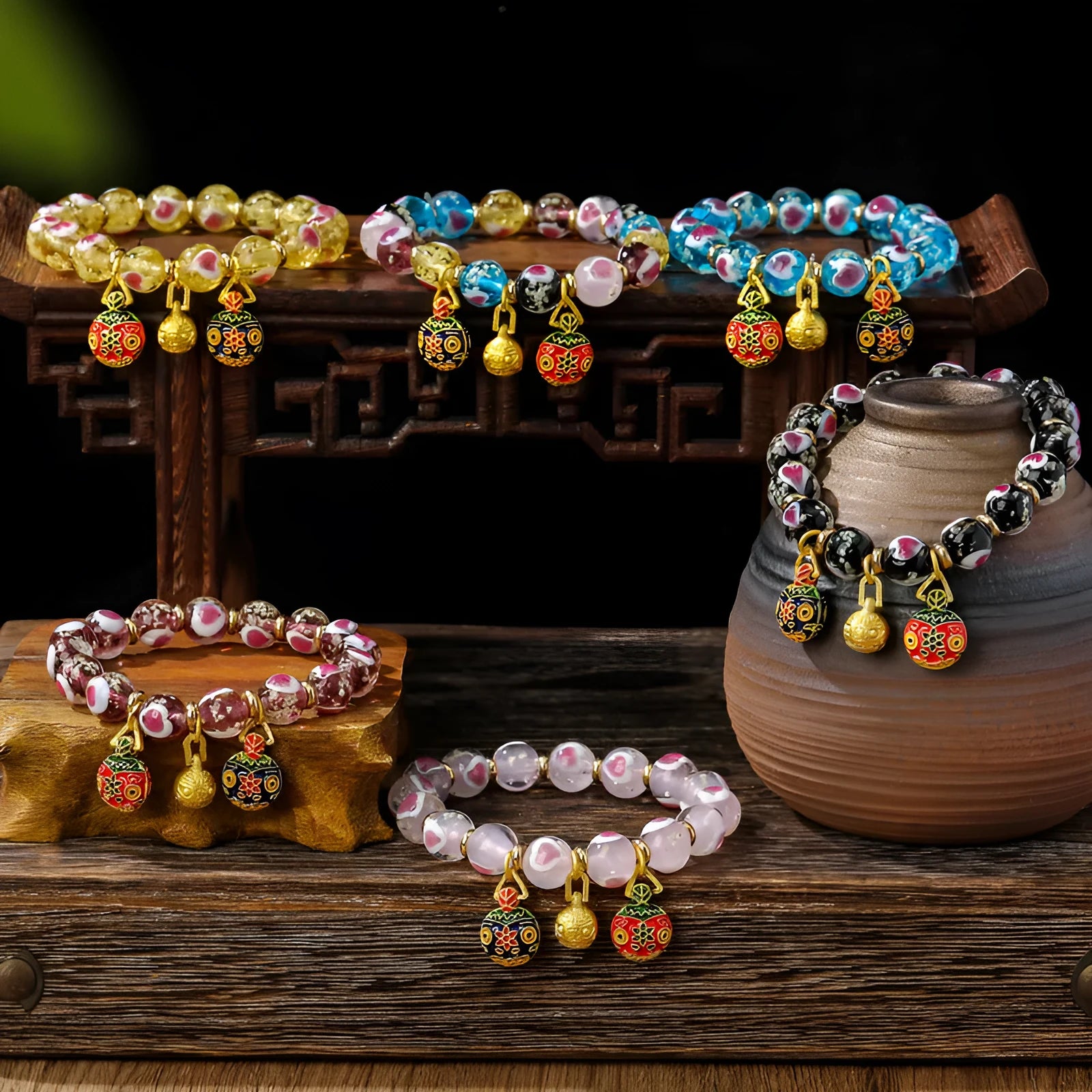 Glass bracelet with 10mm heart beads featuring ancient swallowing gold beast design in multiple colours