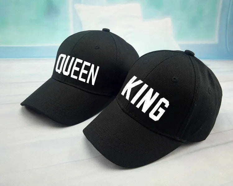 Black printed baseball cap with King design on front, adjustable back strap, on white background