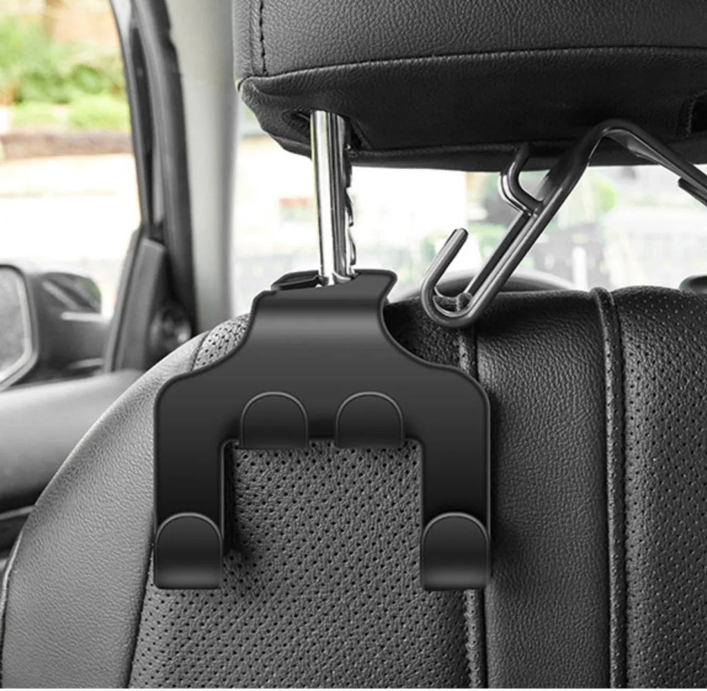 Two white ABS plastic car hooks for mounting phones and organising items in vehicles.