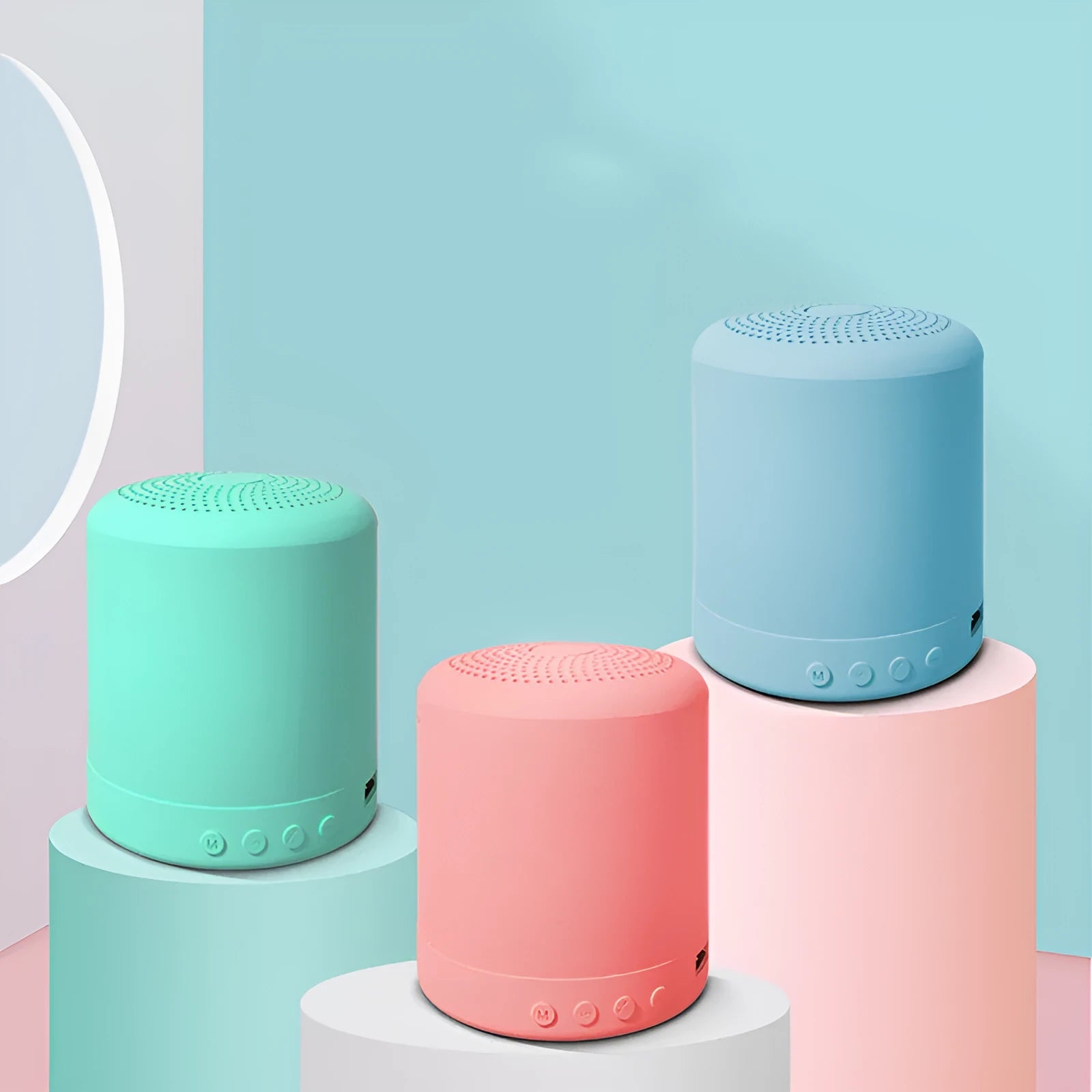 A11 compact wireless subwoofer speaker in black, pink, blue, or green colour on a desk.