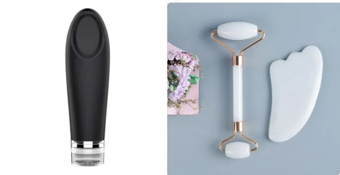 White jade facial roller with double heads and a matching gua sha scraping board on a plain surface.