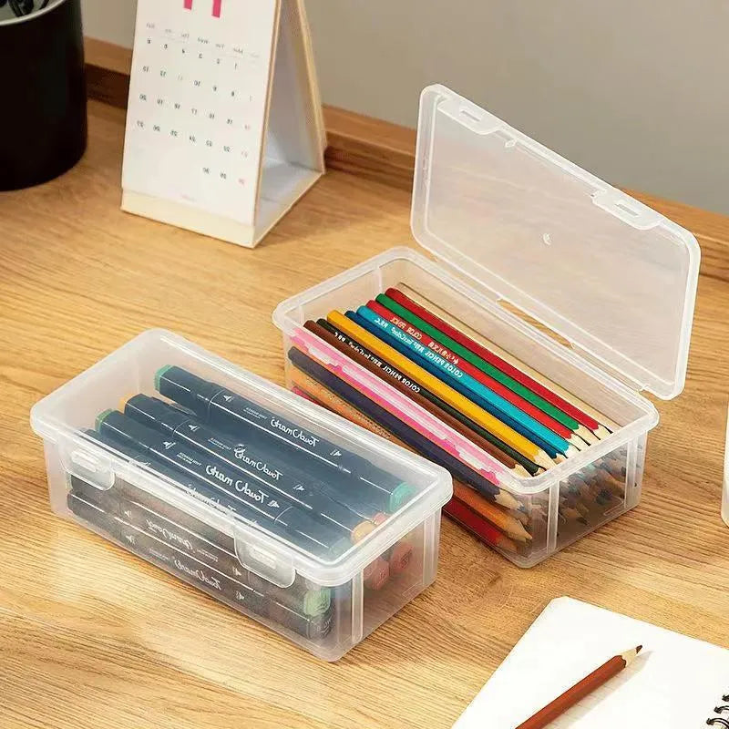 Large transparent plastic stationery storage box holding coloured pencils and crayons.