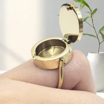 Gold electroplated titanium steel unisex storage ring with future-style round design on a plain background