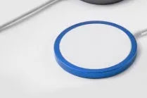 Silver metal magnetic wireless charger compatible with Apple Magsafe for iPhone.