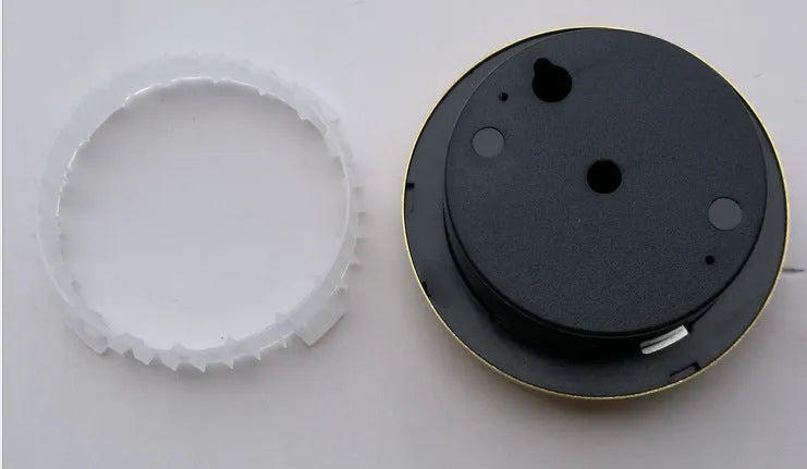 Analogue thermometer and hygrometer with aluminium ring and dial showing temperature and humidity scales.