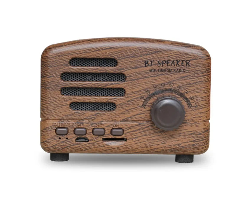 Compact vintage style wood grain Bluetooth speaker on a table next to a mobile phone.