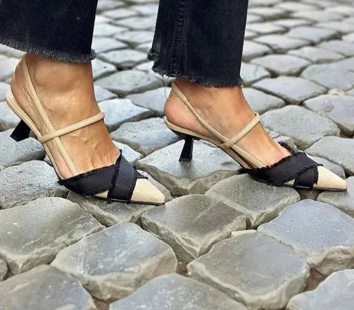 Women's apricot and black colour-block stiletto heel sandals with pointed toe and buckle fastening.
