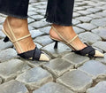 Women's apricot and black colour-block stiletto heel sandals with pointed toe and buckle fastening.