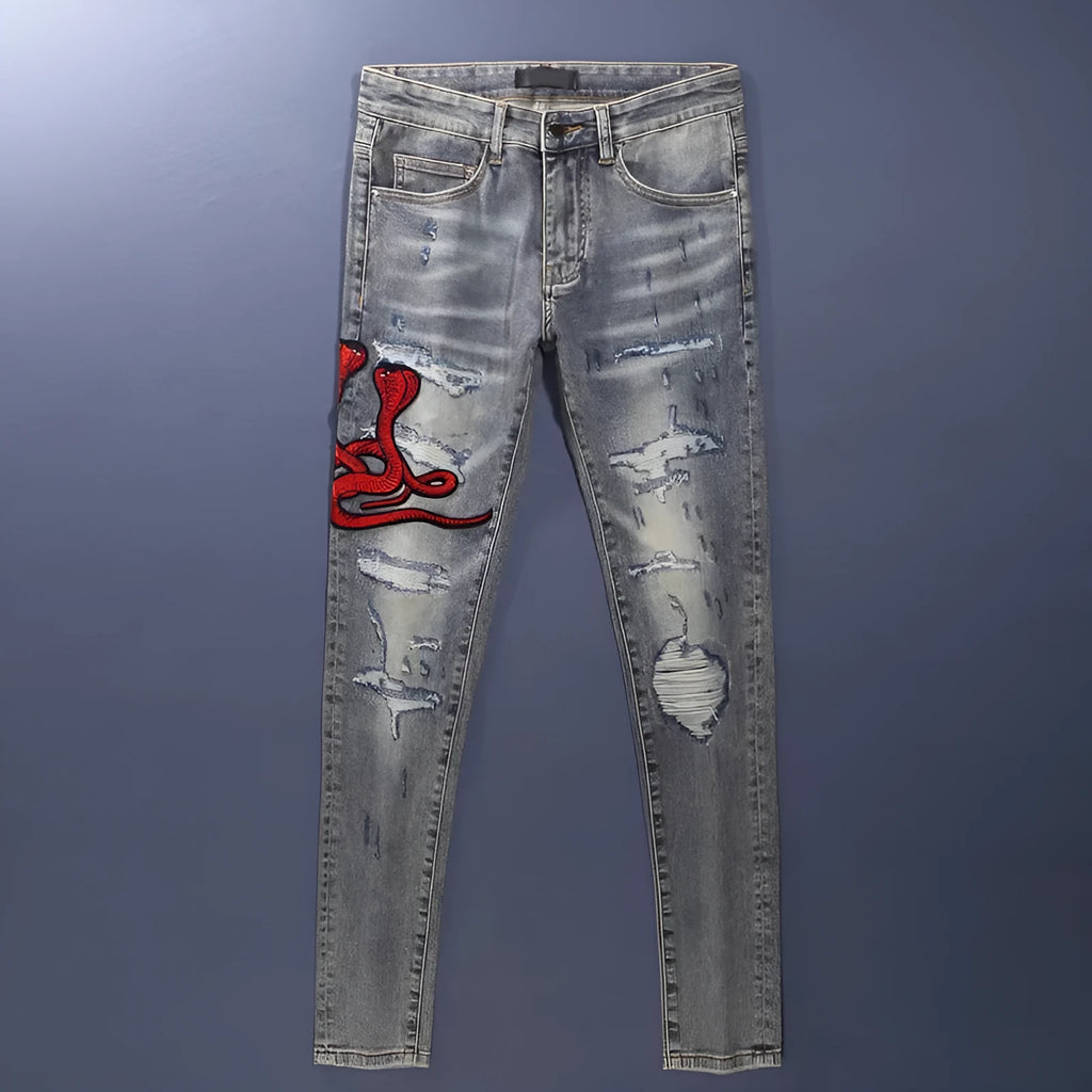 Men's slim fit jeans with embroidered patches and worn wash effect in old colour