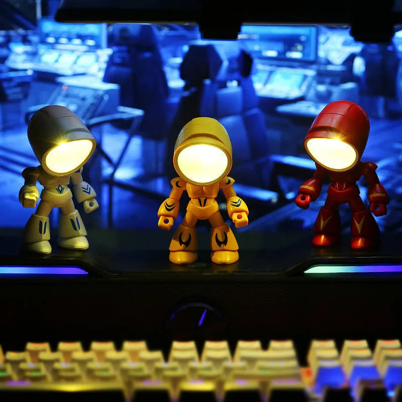 Mini LED hero robot night light with warm glow, adjustable arms, and 360-degree rotating head on a wooden shelf