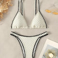 Women's blue and white polyester bikini swimsuit set with briefs style on hanger.
