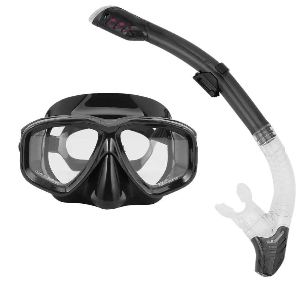 Black diving goggles with clear anti-fog lens, polycarbonate frame, and blue silicone skirt on an adjustable strap.