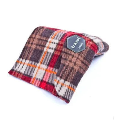 Black U-shaped neck support pillow scarf on a grey background, showing its convex form.
