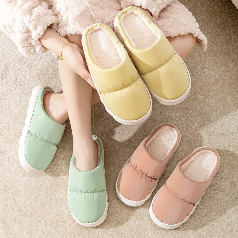 A pair of thick-soled down cotton slippers for men and women in a choice of colours, featuring a non-slip rubber sole.