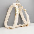 Four-piece dog wedding set with lace vest, matching collar, flower headband, and leash on white background