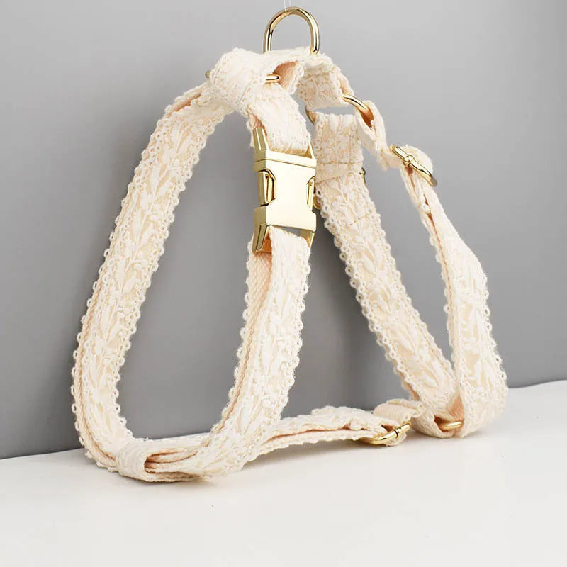Four-piece dog wedding set with lace vest, matching collar, flower headband, and leash on white background