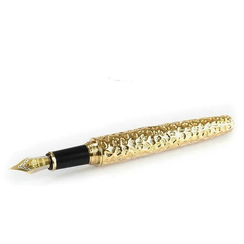Embossed metal business pen in ancient silver or gold colour on a plain background.