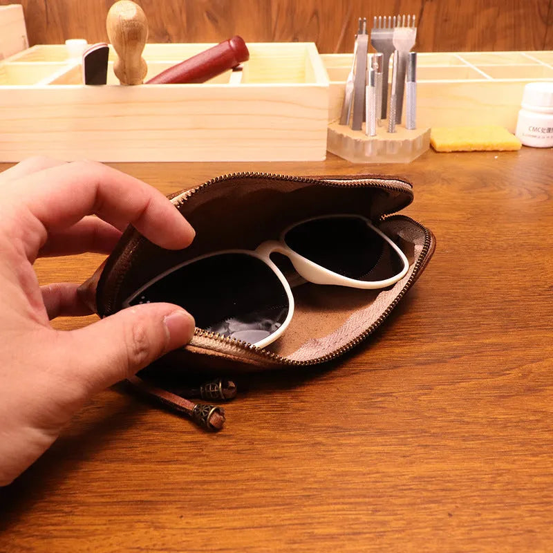 Leather glasses buggy bag in first layer cowhide with belt clip, shown in black, burgundy, brown or light brown.