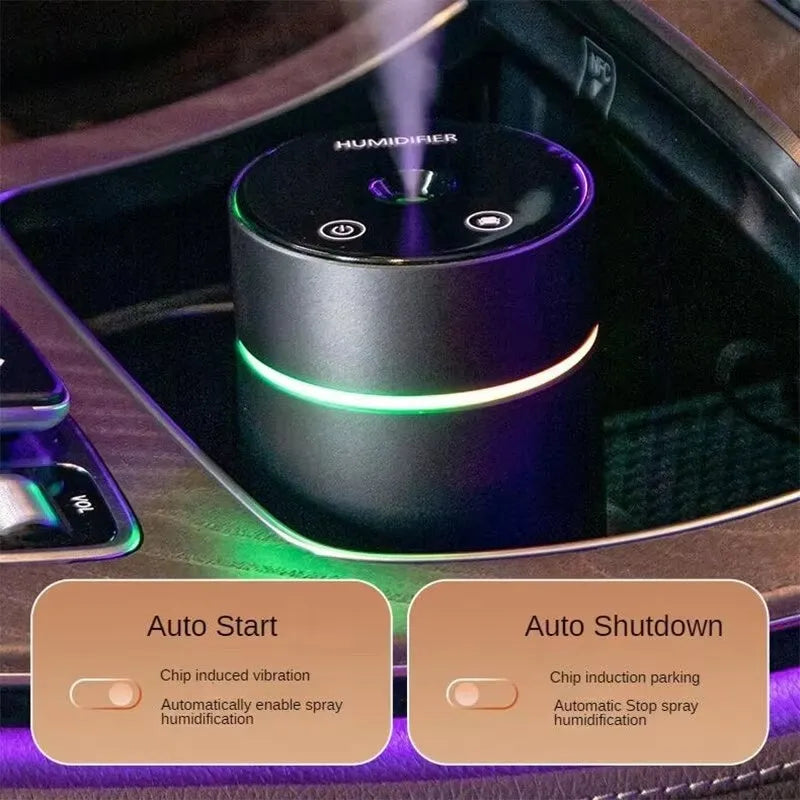 Black portable car humidifier and essential oil diffuser with aluminium body and colourful night light on