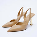 Women's pointed patent leather high heels in apricot colour on a white background.