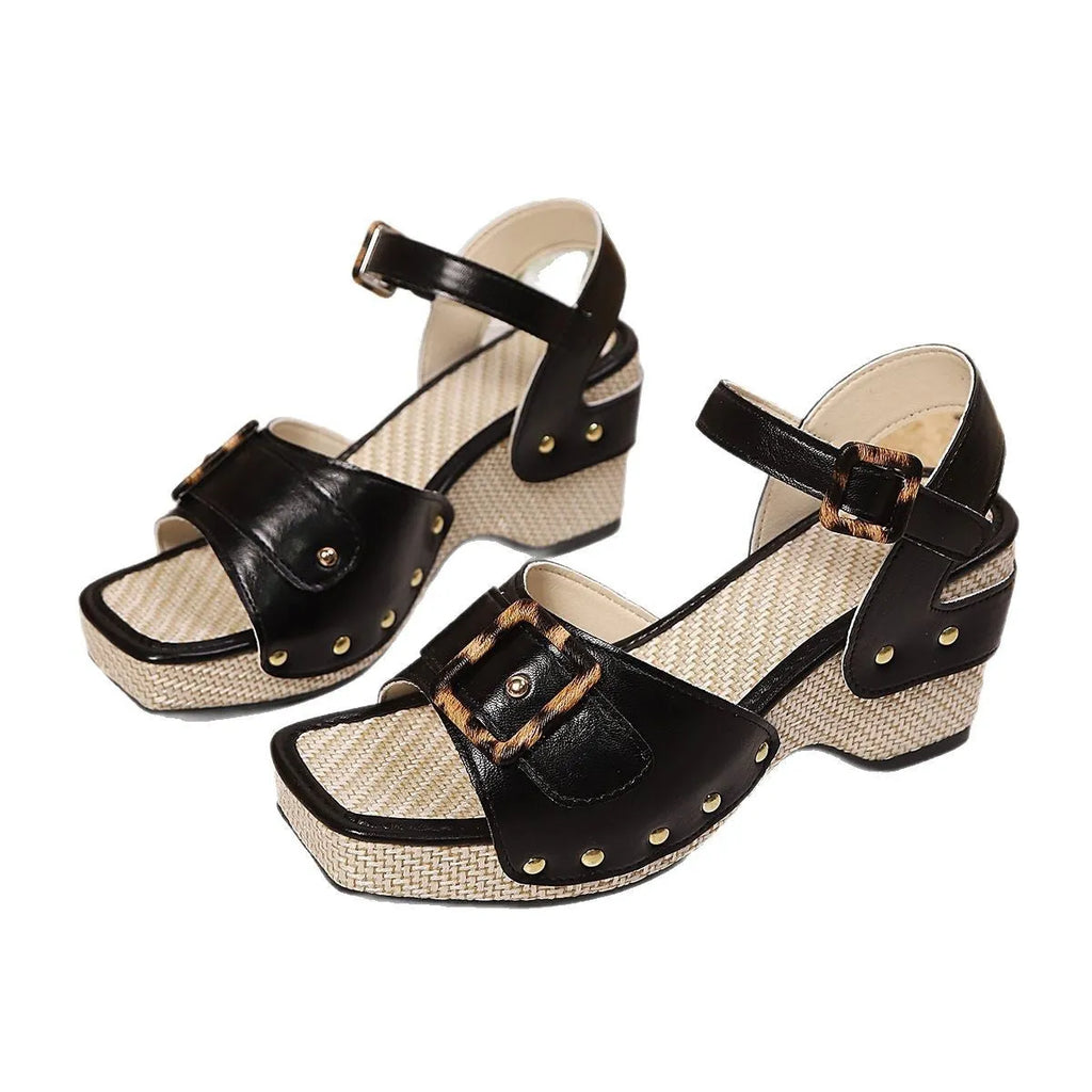 Women's white chunky heel sandals with a square toe and metal buckle closure on a rubber sole.