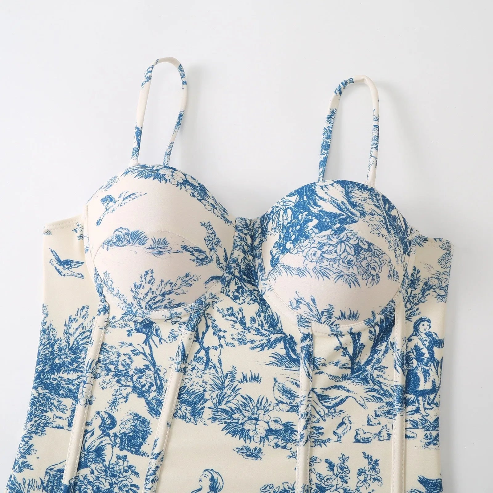 Blue patterned one-piece swimsuit for women with a matching gauze skirt.