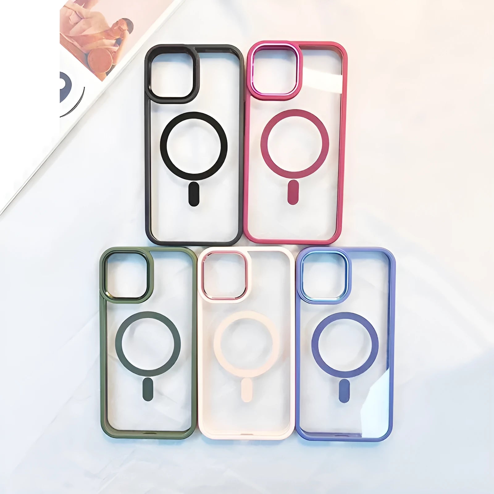 Transparent magnetic silicone phone case for iPhone on a table, showing the solid colour accent and integrated ring.