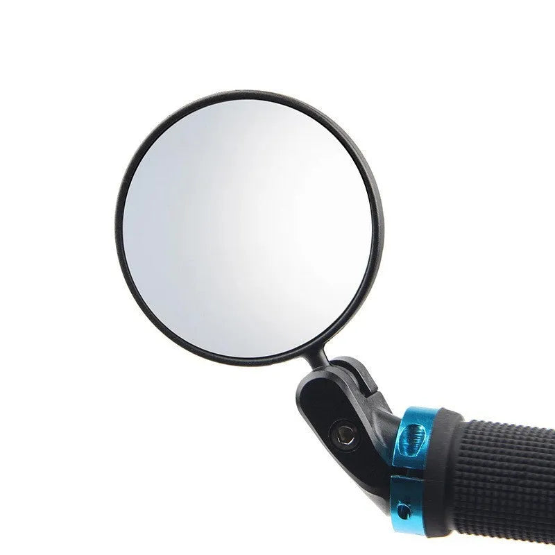 Black foldable convex rearview mirror on a car side mirror, showing its adjustable angle.