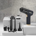 Black wireless handheld car vacuum cleaner with multiple nozzle attachments on charging cable