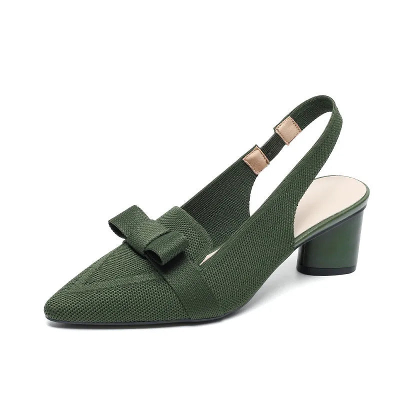 Women's closed toe high heel sandals with bow detail, ankle buckle strap, and pointed toe in a solid colour.
