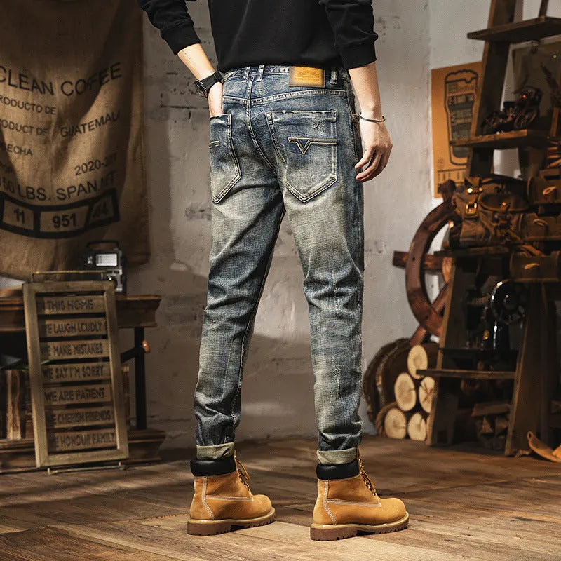 Man wearing vintage blue loose-fit jeans with a fleece lining and drawstring waist.