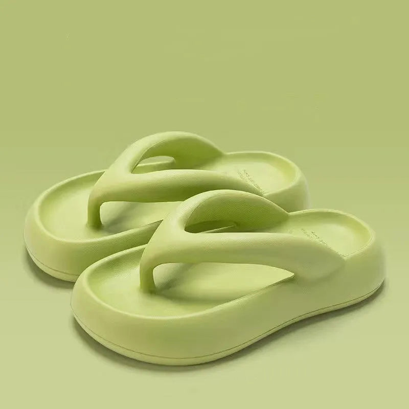 A pair of solid colour thick-soled EVA flip-flops with a bow detail, shown on a light background.