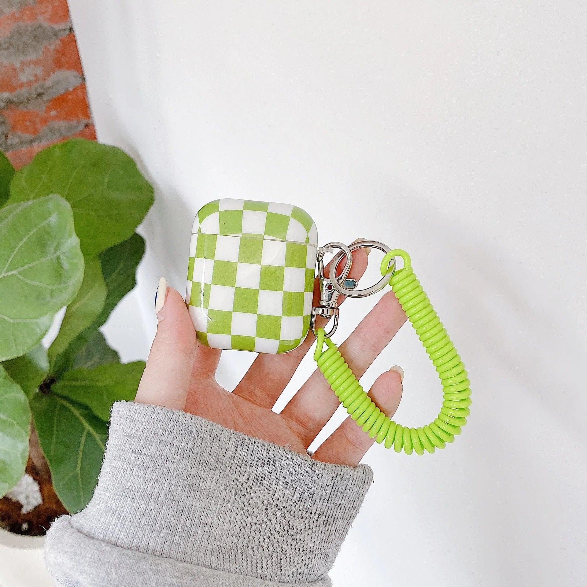 Black and green checkerboard pattern TPU case for Apple AirPods with optional pendant attachments