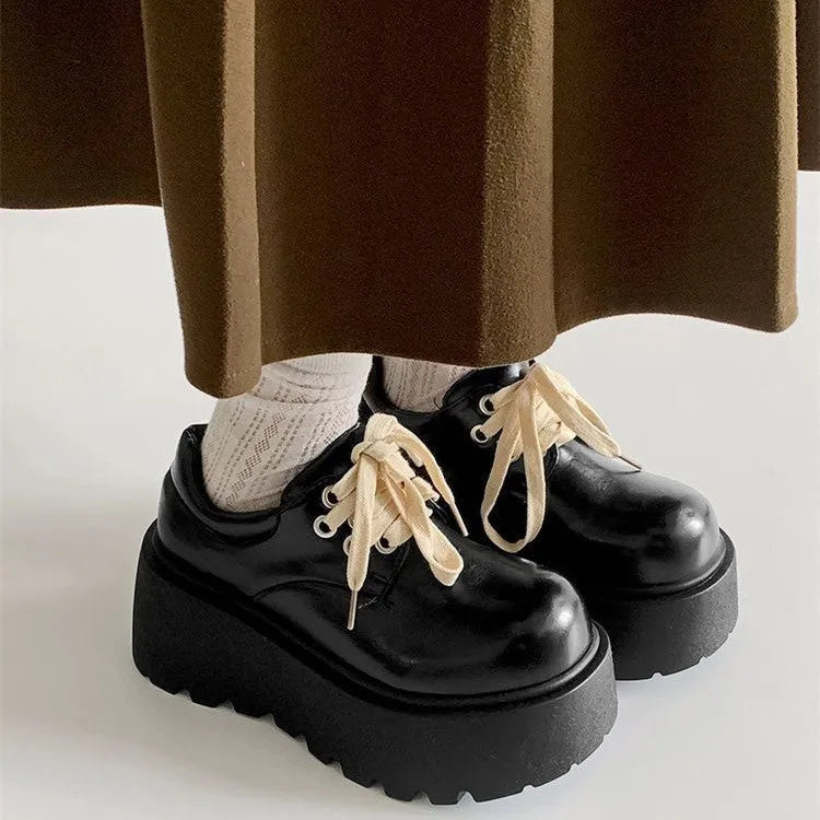 Matte black women's lace-up high-heel shoes with a thick sole and an English muffin heel.