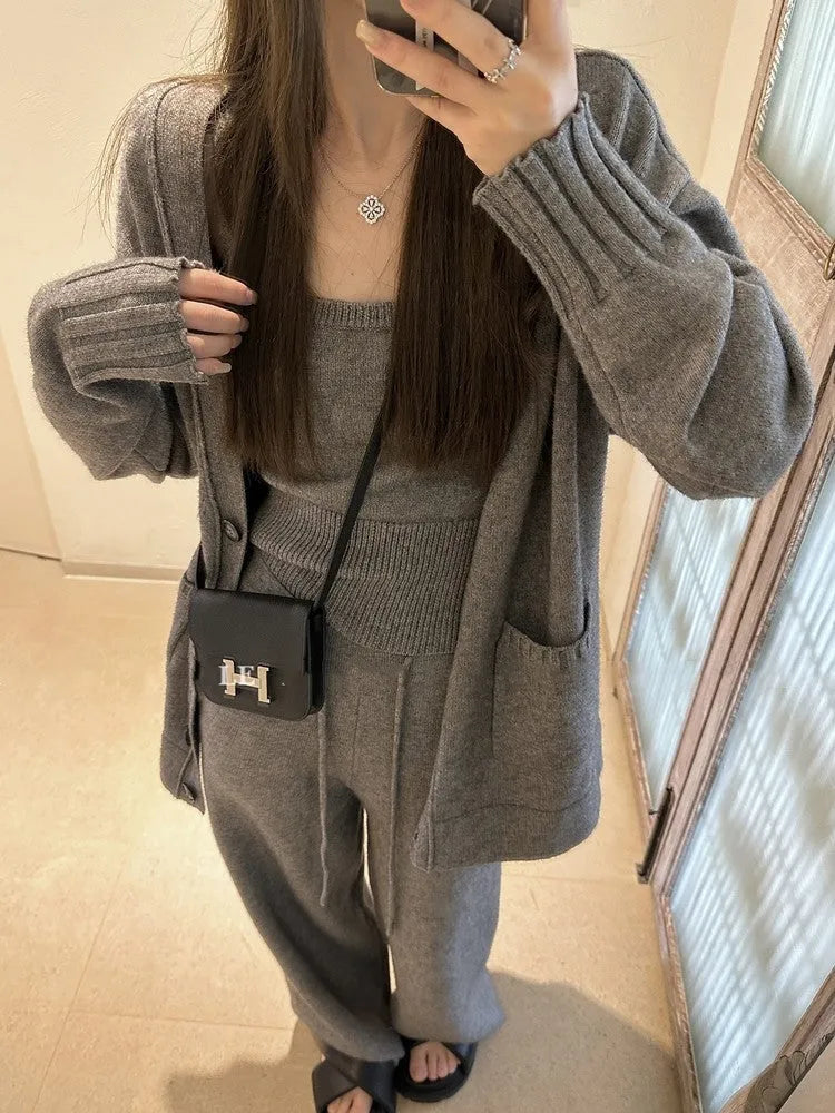 Women's light brown knit cardigan, vest, and casual pants three-piece set laid flat.