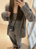 Women's light brown knit cardigan, vest, and casual pants three-piece set laid flat.