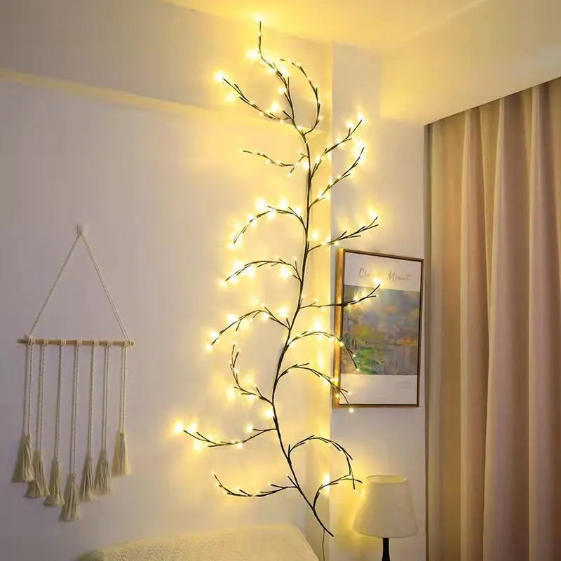 Flexible LED willow vine garland with warm white lights shaped into a decorative curve on a wall.