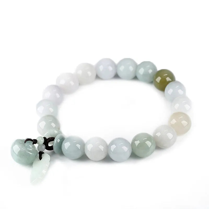 Natural green jade bracelet with a geometric shape and a hanging apple charm on a white background.