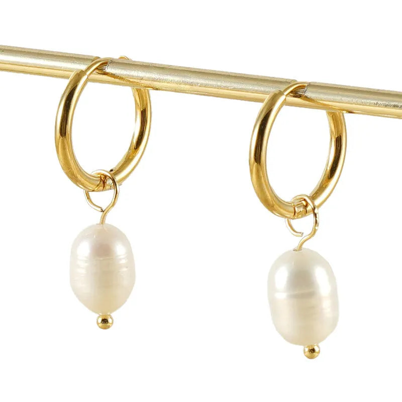 Gold geometric women's drop earrings with a pearl centre on hypoallergenic titanium steel posts.